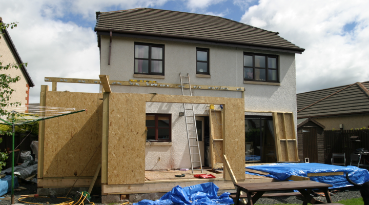 A modern home with an extension being built.